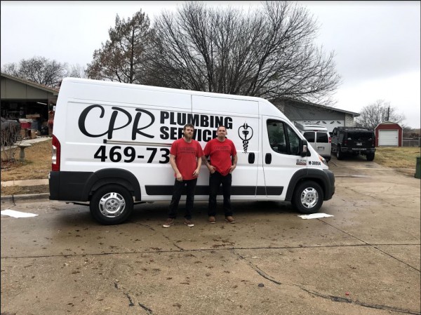 Two plumbers standing in front of a CPR Plumbing Services work van