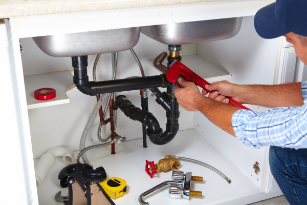 Plumber fixing a kitchen sink