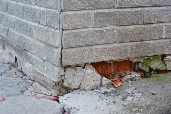 Foundation of a brick house in need of repair