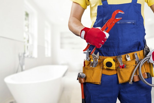 Plumber standing in front of a bath tub