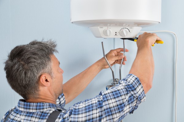 Plumber repairing a water heater